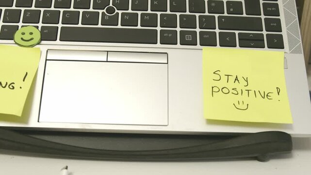 Stay Strong, stay possitive sticky notes on the work laptop. Self Encouragement. High quality 4k footage