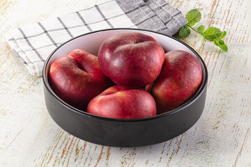 Ripe sweet juicy flat nectarines heap