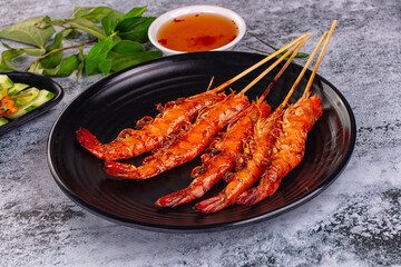 Grilled prawn skewer served sauce