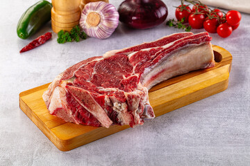 Raw prime beef steak with bone