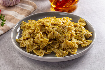 Italian green pasta farfalle with pesto