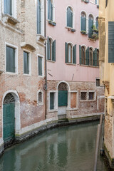 historical buildings on small canal bend, Venezia, Italy
