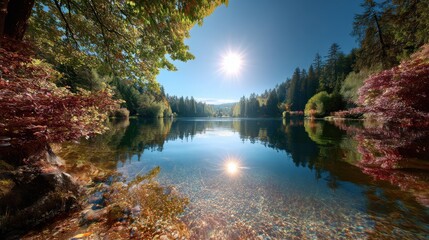 Obraz premium Beautiful lake with calm reflections and bright red leaves under a clear blue sky