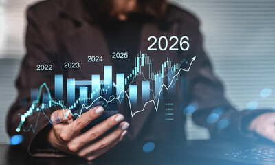 Businesswoman analyzing future financial growth graph with data projections leading to 2026 on transparent screen with rising trend concept.