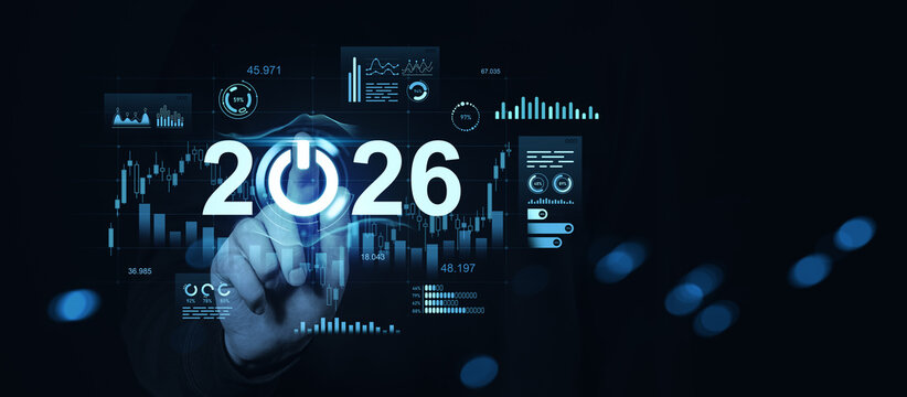 Futuristic 2026 concept with digital data charts and hand pressing power symbol in blue interface on dark background for technology innovation themes.
