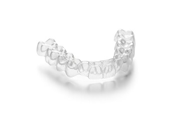 Clear plastic aligner for teeth straightening on a white background studio shot