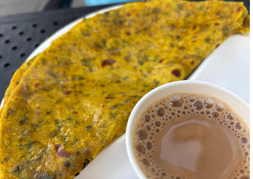 Indian paratha with masala tea. Layered flat bread with greens, hot naan, roti or chapati
