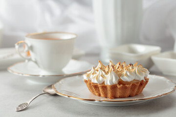 Meringue tart on a white marble countertop.