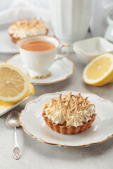 Meringue lemon tart on a white table.