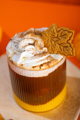 Close up golden latte with turmeric on a orange background. Moon milk for better sleep. Ayurvedic drink. Copy space.