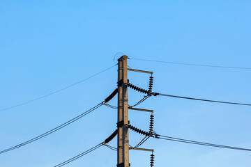 High voltage electric power lines and pylons against a blue sky