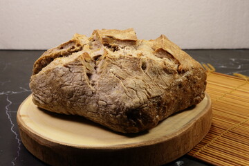 Classic walnut sour dough on the wooden board. Famous bread bakery in French.	
