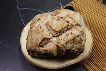 Classic walnut sour dough on the wooden board. Famous bread bakery in French.	
