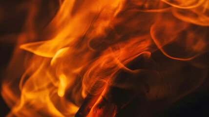 Close up abstract view of vibrant orange and yellow flames against a dark background