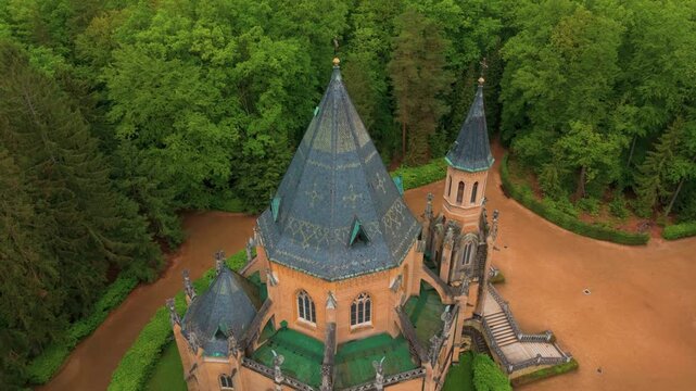 An aerial drone shot captures the magnificent neo Gothic Schwarzenberg Tomb in Třeboň, South Bohemia, Czech Republic, surrounded by lush green forest. This historic monument, also known as Schwarzenbe