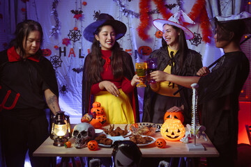 Asian man and woman celebrating Halloween, pumpkins at night, Halloween banner background for holiday activities.