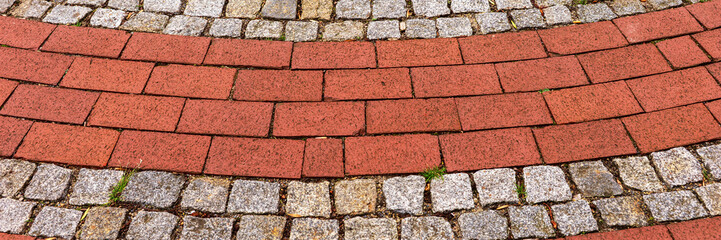 Panoramic image. Red cobblestones arranged in round