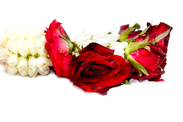 Fresh flower garlands made from red rose and jasmine flowers for use in ceremonies in Thailand such as Buddhist rituals and auspicious events.
