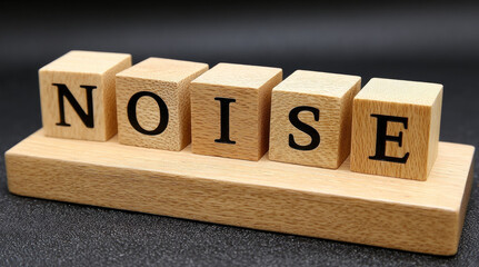 Noise spelled wooden block letter, arranged row wooden base, black background, concept of sound, chaos, disturbance, simple clear style