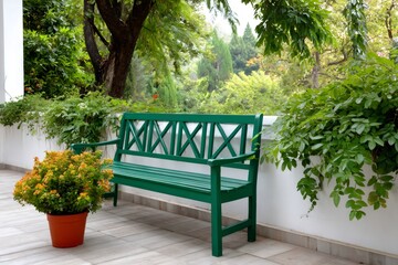 Obraz premium Green bench on terrace creating a peaceful garden setting