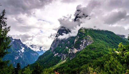 Dramatic mountain landscape with clouds, trees, and scenic natural environment