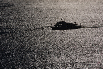 Bodensee, Schiff auf den Wellen im Gegenlicht
