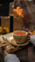 Cozy autumn scene with a cup of tea and a book