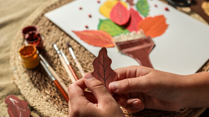 Autumn art project with colorful leaves and paint