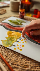 Autumn art project with leaves and paint