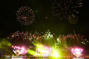 Gorgeous fireworks blooming on the lake in the tourist area