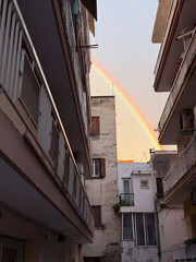 Rainbow over residential buildings in Thessaloniki, Greece at sunset