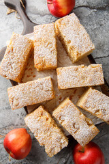 Applesauce cake is a dessert cake prepared using apple sauce, flour and sugar close-up on wooden board on a table. Vertical top view from above