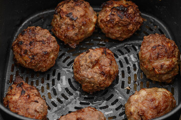 Minced meatballs baked in a fat-free fryer, round brown meatballs
