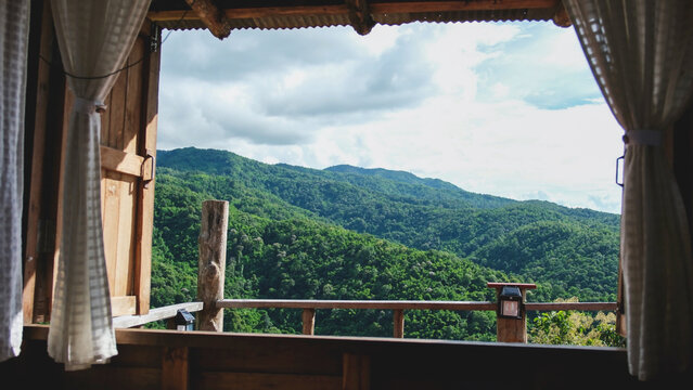 Fototapeta Landscape view of greenery forest and mountain views outside the window