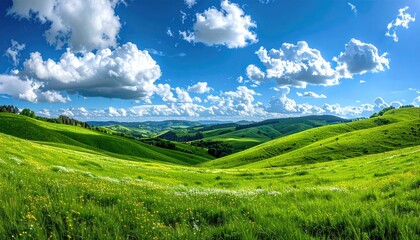 Obraz premium Scenic Green Hills Under a Blue Sky with Clouds During the Daytime