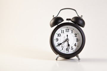 Black alarm clock isolated on white background with copy space for text.