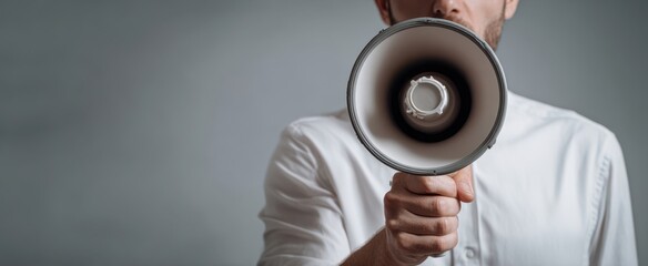 The megaphone held by a man delivering a bold announcement in studio