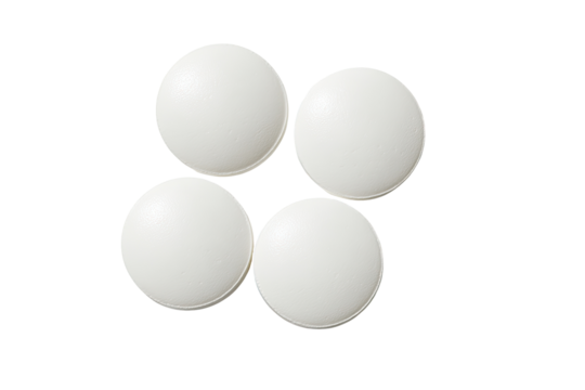 Four white, round pills arranged in a starburst pattern