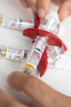 Hands holding Methofill methotrexate prefilled syringes for injection
