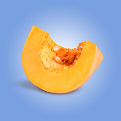 Slice of ripe pumpkin on pale blue background
