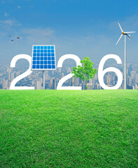 2026 white text with solar cell, wind turbine and growing tree on green grass field over modern city tower and skyscraper, Happy new year 2026 ecological cover concept