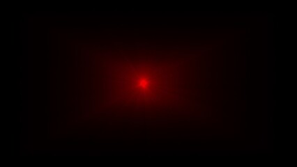 Small, intense red light source glowing in the center of a dark frame bright