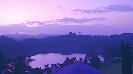 Purple sunset over a tranquil lake surrounded by rolling hills, nature landscape