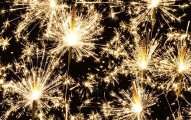 Bright golden sparklers isolated on a dark background for celebrations