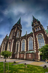 Fototapeta premium Neo Gothic Polish cathedral Olga and Elizabeth in Lviv city spires under dramatic skies