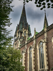 Fototapeta premium Neo Gothic Polish cathedral Olga and Elizabeth in Lviv city spires under dramatic skies