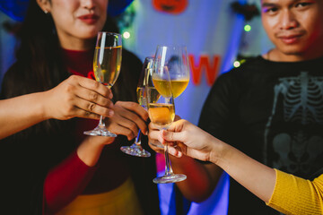 Close-up of people toasting with glasses of champagne or wine, celebrating together at a festive party with joyful atmosphere.