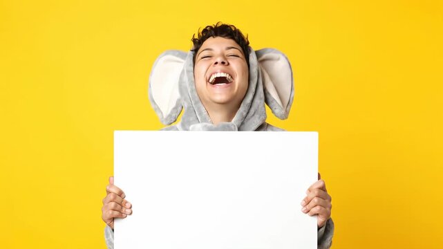 Woman in Elephant Costume Holds Blank Sign on Yellow Background