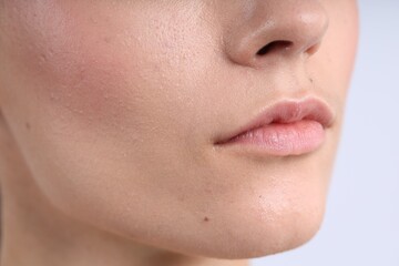Woman with normal skin on light background, closeup