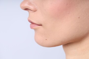 Obraz premium Woman with normal skin on light background, closeup. Space for text